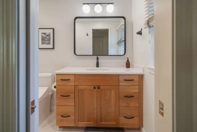 Primary bathroom remodel in Cayuga Heights, Ithaca with a cherry double vanity and quartz top